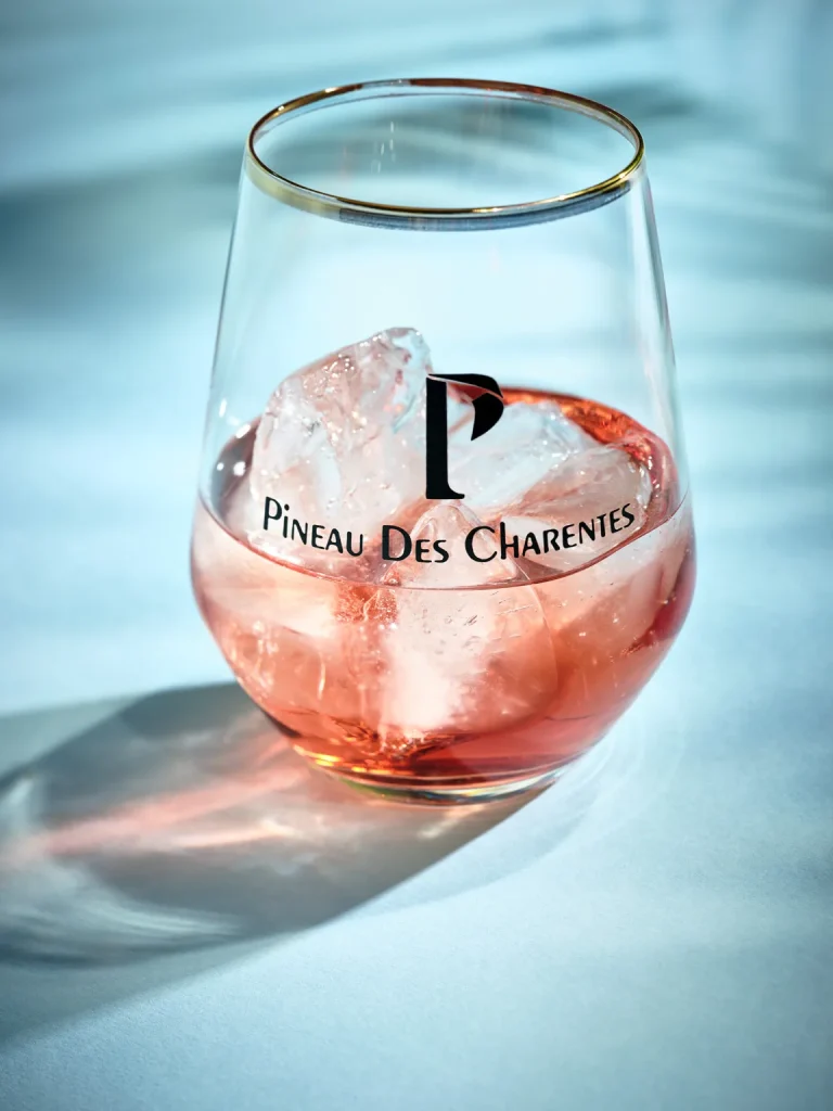 Glass of pineau des Charentes rosé with ice