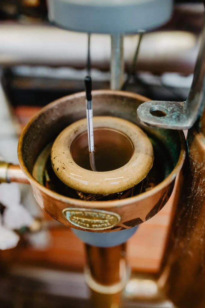 Double distillation of cognac, the copper alcoometer holder at the Boinaud distillery in Angeac Champagne, in the Grand Champagne region