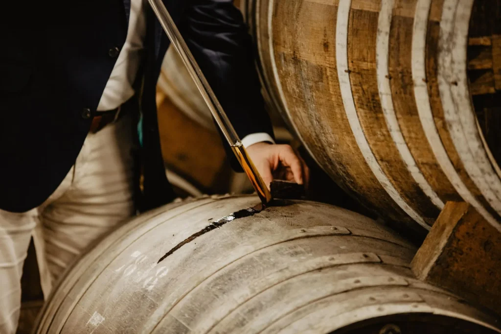 Control of Boinaud cognac eaux-de-vie during ageing, cognac barrel in a cellar.