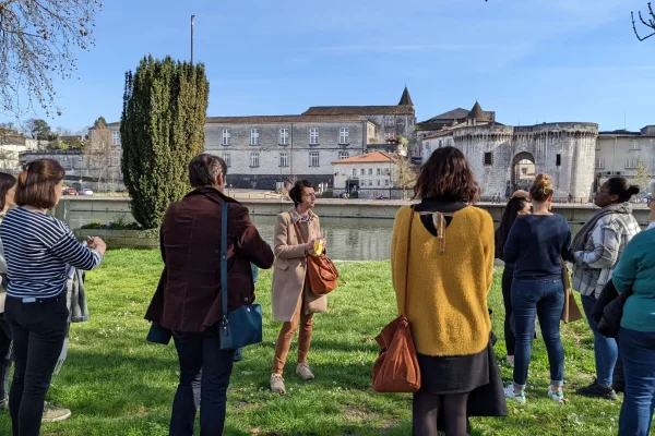 Visits by Nath, Cognac from the Middle Ages to the present day in front of the river Charente on the bank of the Saint Jacques district in Cognac with the Saint jacques towers in the background, the old city gates and the royal castle of Cognac, birthplace of François 1st.
