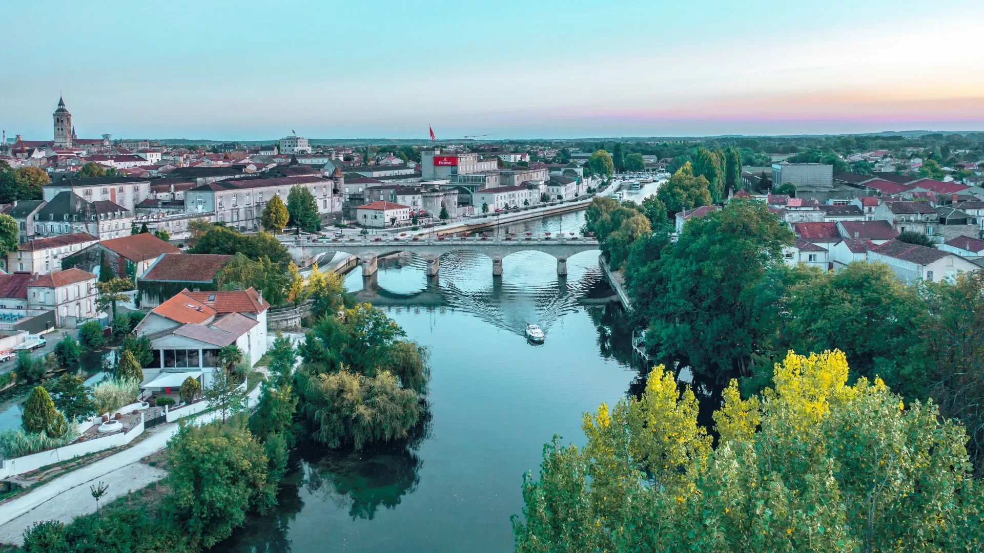 Aerial view of the town of Cognac, in particular the river Charente, the Pont neuf also known as the Pont Saint Jacques, the Chateau de Cognac, the tous saint Jacques, and the quays along which the Otard and Hennessy trading houses are located.
