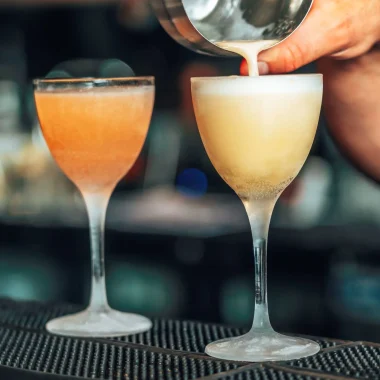 Barman who prepares a cocktail in a glass